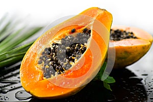 Papaya Exotic fruits close up. Papaya orange fresh fruits border design with tropical palm leaf