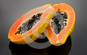 Papaya fruit on black background. Fresh organic Papaya exotic fruits close up. Healthy vegan papayas