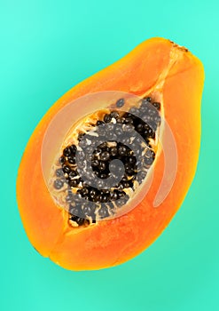 Papaya fruit on blue background, fresh exotic fruits design. Half of fresh organic Papaya exotic fruit