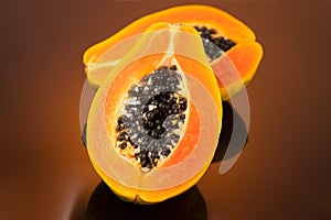 Papaya fruit on brown background. Fresh organic Papaya exotic fruits close up. Healthy vegan papayas