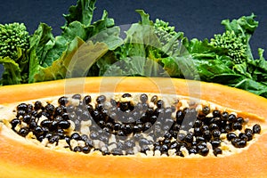 Papaya fruit close-up photo on the black background