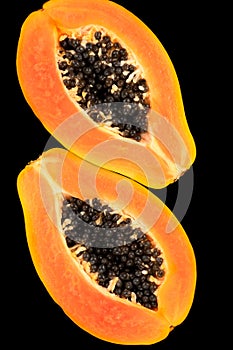 Papaya fruit isolated on black background. Half of fresh organic Ripe Papaya exotic fruit close up