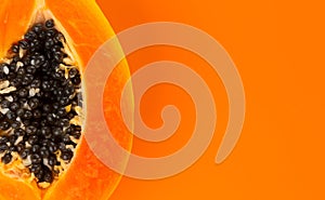 Papaya fruit on orange, yellow background. Halved fresh organic Papaya exotic fruit border design