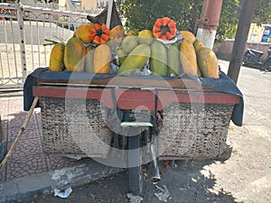 Papaya fruit is sold on motorbikes in traditional markets