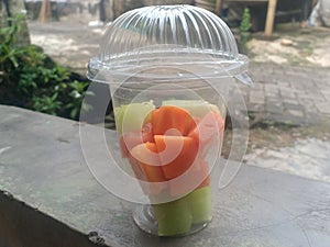 Papaya and melon fruit in a cup