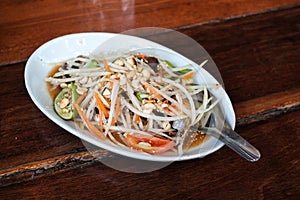 Papaya Salad Thai Food Style on wooden table background