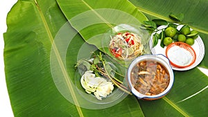 Papaya Slad and Spicy Pork Soup with noodle set on banana leaf