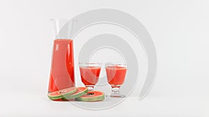 Papaya smoothie in glass jar and glasses on white background