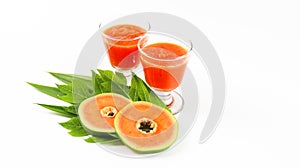 Papaya smoothie in glass jar and glasses on white background