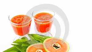 Papaya smoothie in glass jar and glasses on white background