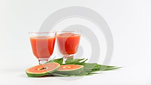 Papaya smoothie in glass jar and glasses on white background