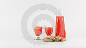 Papaya smoothie in glass jar and glasses on white background