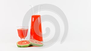 Papaya smoothie in glass jar and glasses on white background