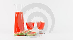 Papaya smoothie in glass jar and glasses on white background