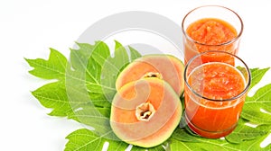 Papaya smoothie in glass jar and glasses on white background