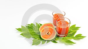 Papaya smoothie in glass jar and glasses on white background