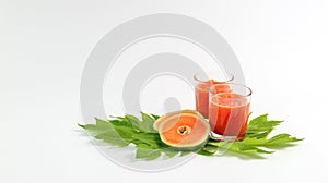 Papaya smoothie in glass jar and glasses on white background