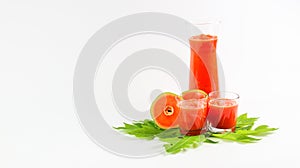 Papaya smoothie in glass jar and glasses on white background