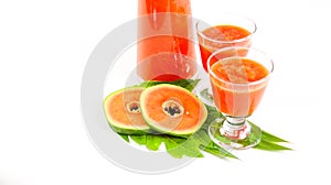 Papaya smoothie in glass jar and glasses on white background