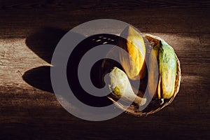 Papaya in a wicker basket on a wooden table