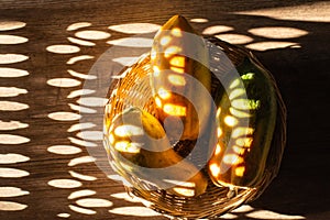 Papaya in a wicker basket on a wooden table, Light and shadow of sunshine.