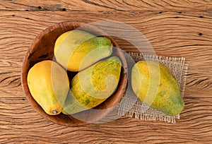 Papayas on a bowl over wooden table