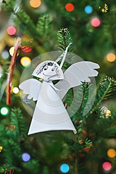 Paper angel hanging on Christmas tree