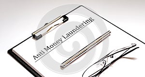 Paper with Anti-money laundering AML on a table