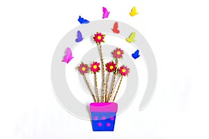 Paper art flowers on vase with butterfy on white background