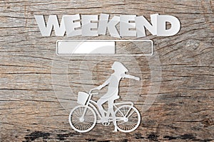 Paper art of WEEKEND loading text on wooden table