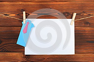 Paper attach to rope with clothes pins on wooden background - Image