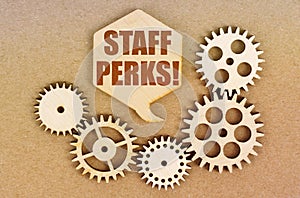 On a paper background, gears and a thought plate with the inscription - Staff Perks