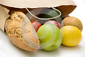 Paper bag with bread, fruits and vegetables