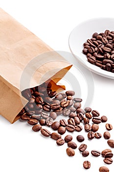 Paper bag with coffee beans and saucer