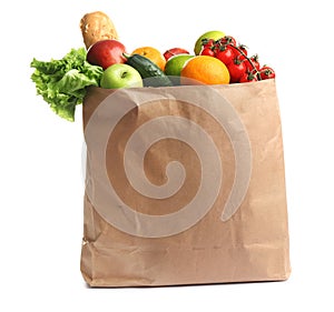 Paper bag with different groceries on white