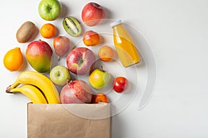 Paper bag of different health fruits on a table