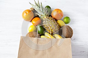 Paper bag of different tropical fruits