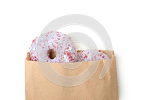 Paper bag with donuts isolated on white background