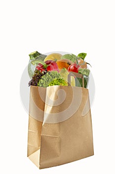 A paper bag filled with vegetables and fruits. Purchase of products.Isolated objects on white background