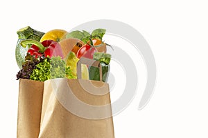 A paper bag filled with vegetables and fruits. Purchase of products.Isolated objects on white background