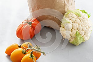 Paper bag with healthy food gray background