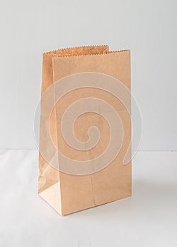 Paper bag isolated on white background with clipping path, eco-friendly brown food package mockup for lunch, breakfast or dinner