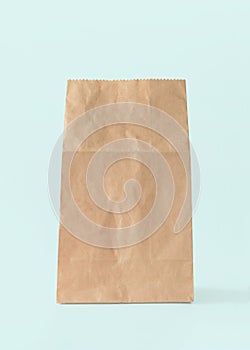 Paper bag isolated on white blue background with clipping path, eco-friendly brown food package mockup for lunch, breakfast