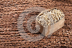 Paper bag with pearl barley - Hordeum vulgare photo