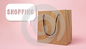 Paper bag on pink background. Purchase and sale of goods via the Internet.