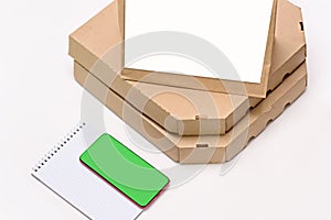 Paper bag and pizza delivery boxes on white table background