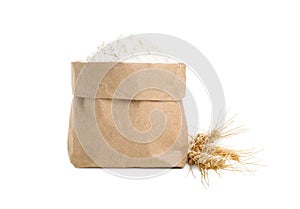 Paper bag with wheat flour and spikes isolated on white