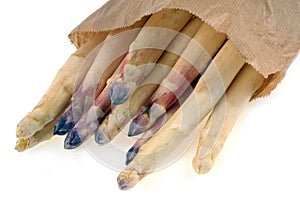 Paper bag of white asparagus close up on white background