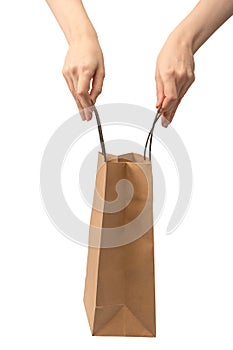 Paper bag in woman hand isolated on a white background