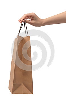 Paper bag in woman hand isolated on a white background